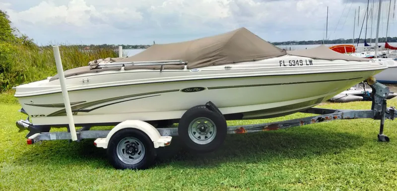 Slide: The Image of 2002 Sea Ray 176 Bow Rider on trailer, covered, parked on grass. - 17
