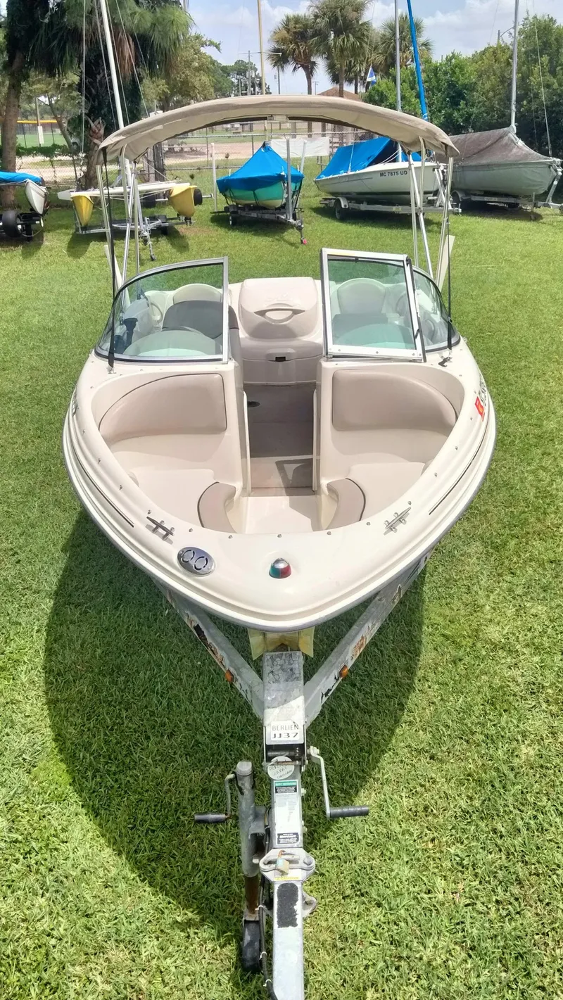Slide: The Image of 2002 Sea Ray 176 Bow Rider boat on grass, front view. - 3