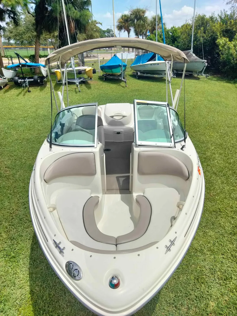 Slide: The Image of 2002 Sea Ray 176 Bow Rider boat on grass, with open seating and canopy. - 4