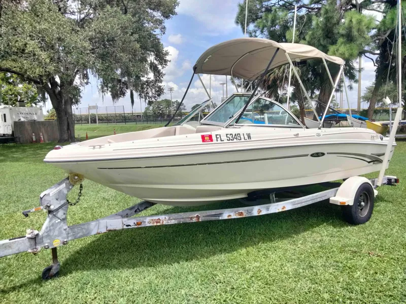 Slide: The Image of 2002 Sea Ray 176 Bow Rider boat on trailer, parked on grass. - 5