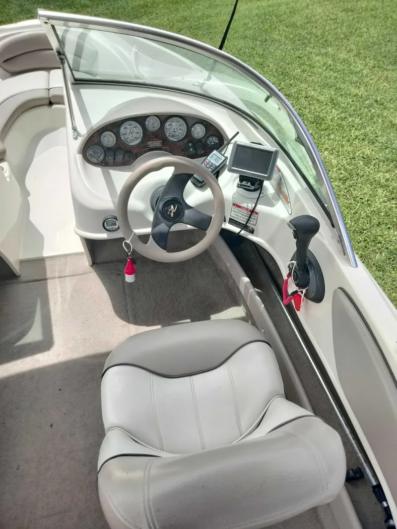 Slide: The Image of 2002 Sea Ray 176 Bow Rider interior with steering wheel and dashboard controls. - 8