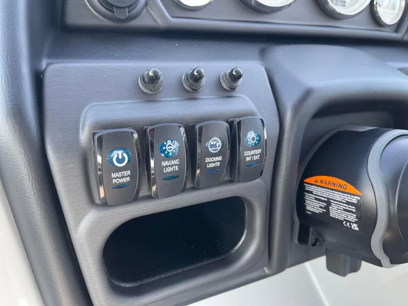 Slide: The Image of Control panel of 2025 Bentley Pontoons Legacy 203 Navigator with labeled switches. - 11