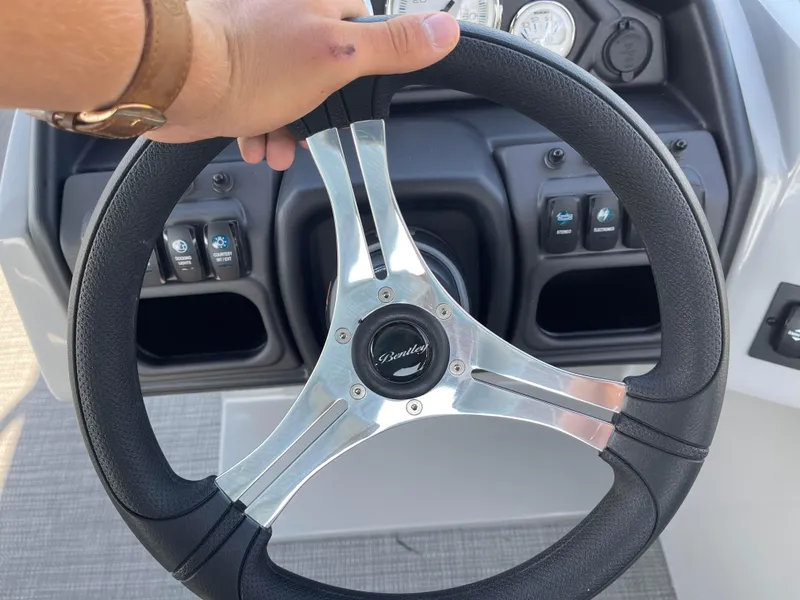 Slide: The Image of Steering wheel of 2025 Bentley Pontoons Legacy 203 Navigator boat, close-up view. - 13