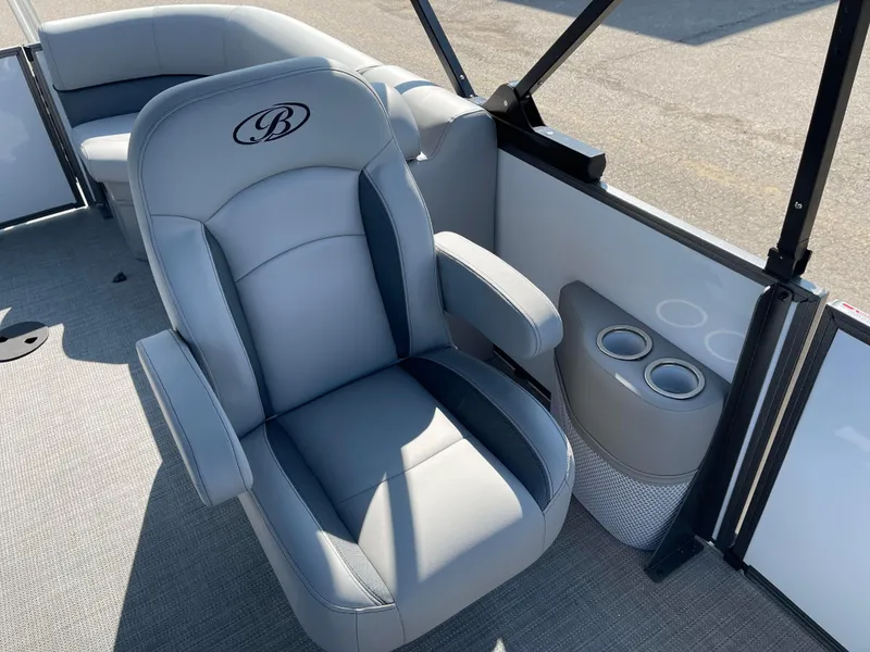 Slide: The Image of 2025 Bentley Pontoons Legacy 203 Navigator interior with luxurious seating and cup holders. - 17