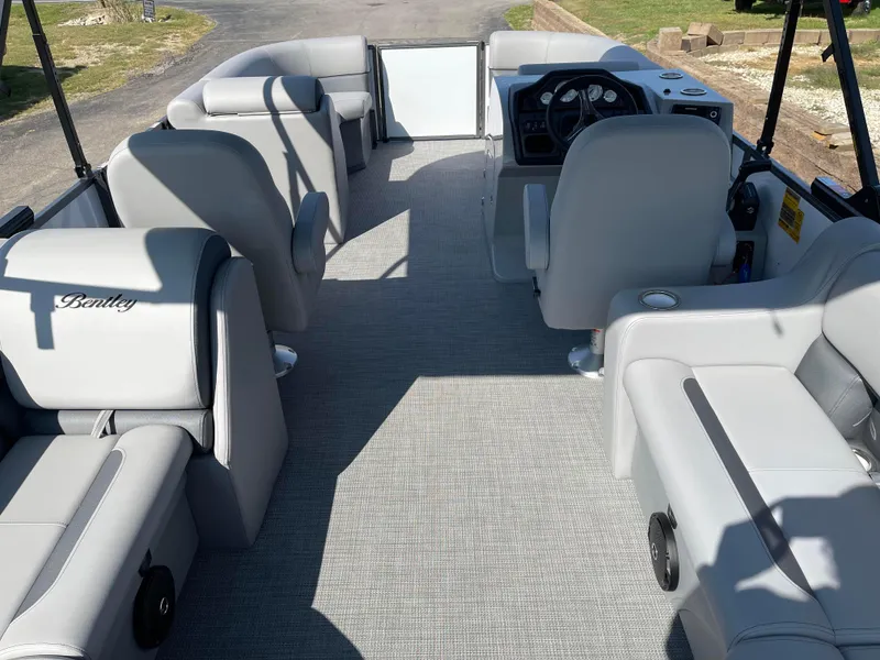 Slide: The Image of 2025 Bentley Pontoons Legacy 203 Navigator interior with gray seating and steering console. - 19