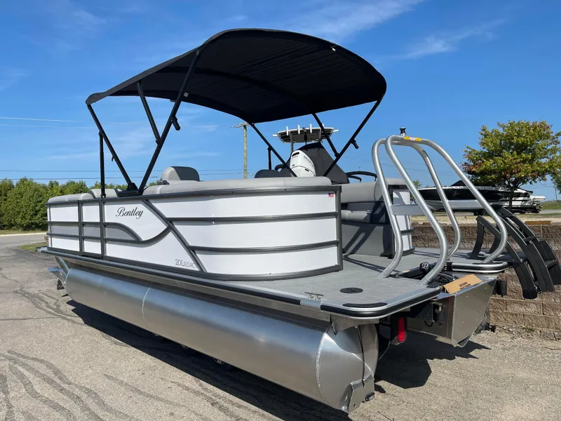 Slide: The Image of 2025 Bentley Pontoons Legacy 203 Navigator, sleek design, outdoor setting, sunny day. - 2