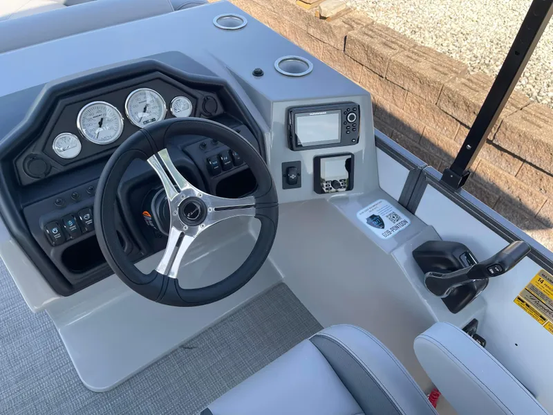 Slide: The Image of 2025 Bentley Pontoons Legacy 203 Navigator dashboard with steering wheel and gauges. - 9