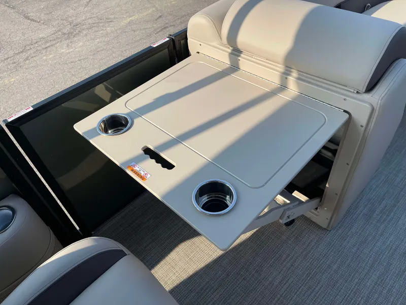 Slide: The Image of 2025 Bentley Pontoons Legacy 203 Swingback interior with foldable table and cup holders. - 12