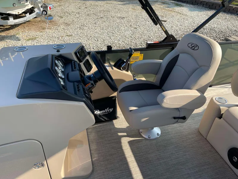 Slide: The Image of 2025 Bentley Pontoons Legacy 203 Swingback helm with captain's chair and control panel. - 14