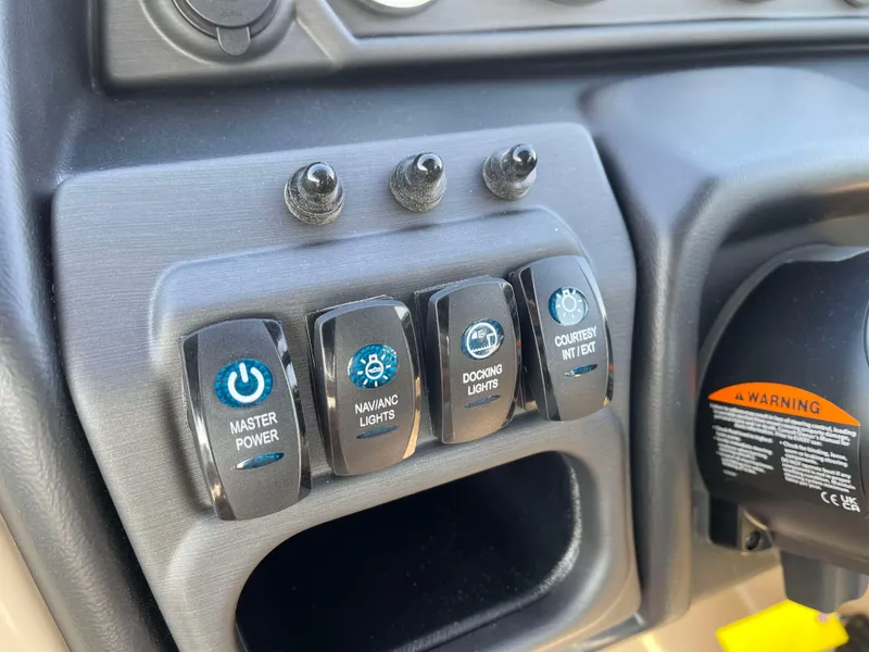 Slide: The Image of Control panel of 2025 Bentley Pontoons Legacy 203 Swingback with power and light switches. - 16