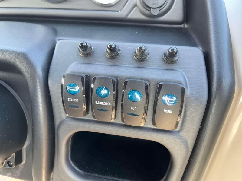 Slide: The Image of Control panel of 2025 Bentley Pontoons Legacy 203 Swingback with labeled switches. - 18