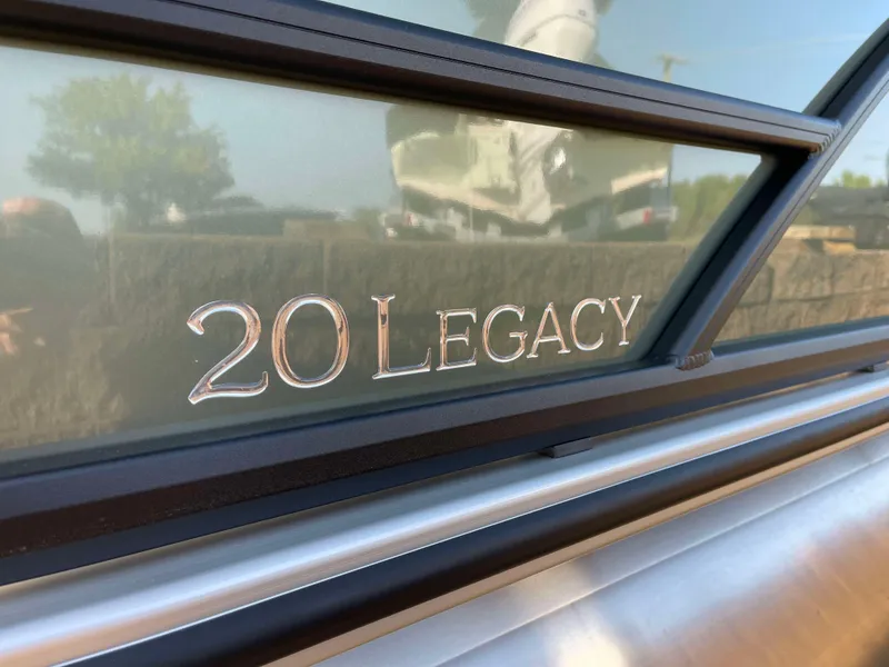 Slide: The Image of Close-up of 2025 Bentley Pontoons Legacy 203 Swingback logo on boat exterior. - 2