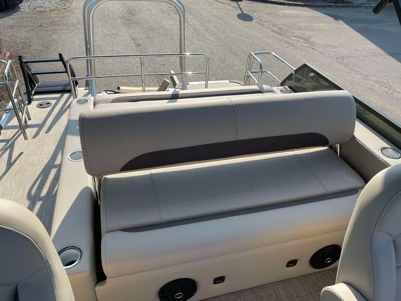 Slide: The Image of 2025 Bentley Pontoons Legacy 203 Swingback interior with beige seating and cup holders. - 21