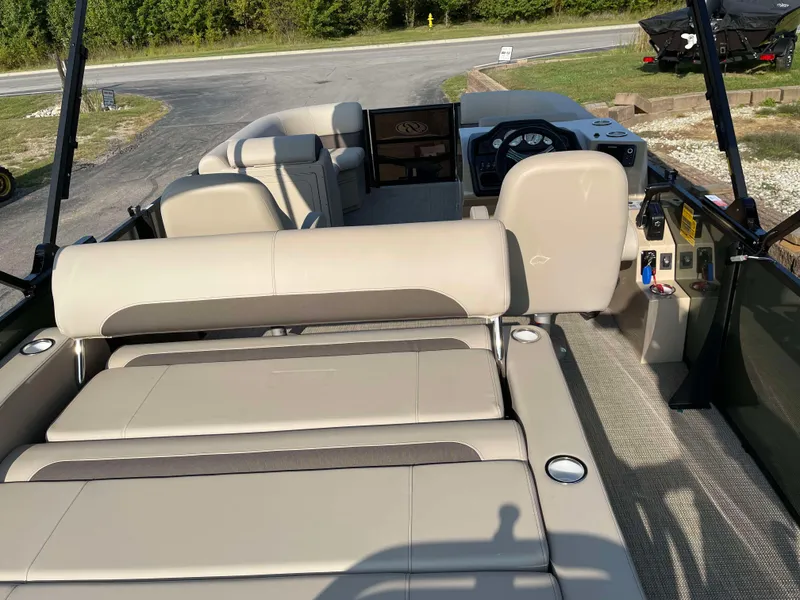 Slide: The Image of 2025 Bentley Pontoons Legacy 203 Swingback interior with beige seating and modern dashboard. - 23