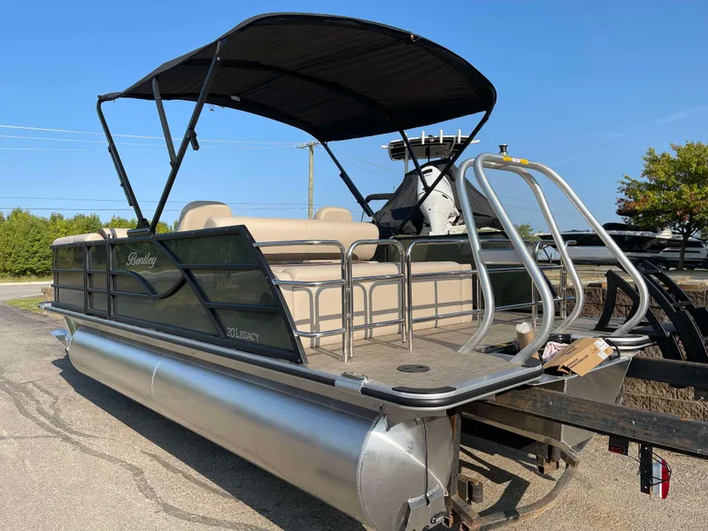Slide: The Image of 2025 Bentley Pontoons Legacy 203 Swingback with canopy, parked on a trailer. - 3