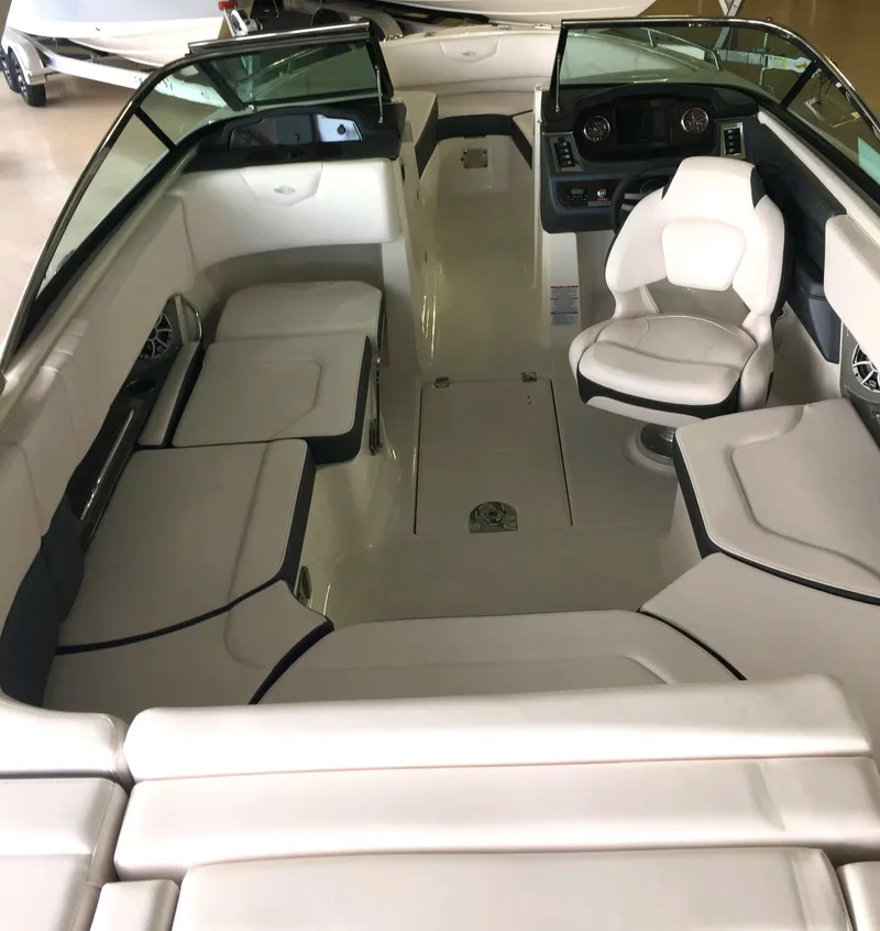 Slide: The Image of 2019 Chaparral 237 SSX boat interior with white seating and modern dashboard. - 13