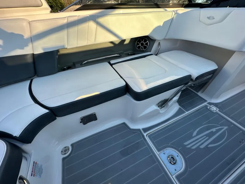 Slide: The Image of 2019 Chaparral 237 SSX boat interior with white and gray seating and flooring. - 14