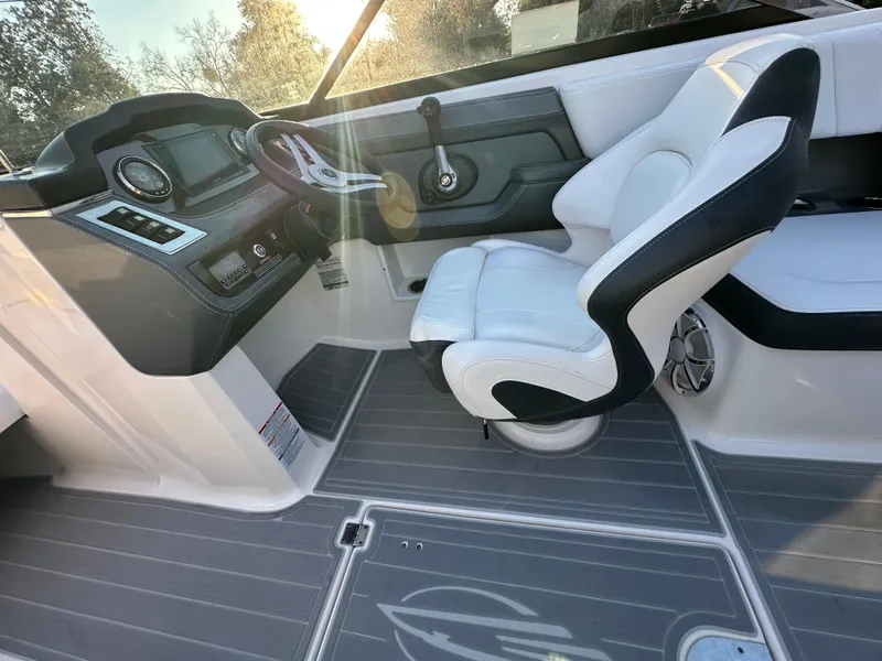 Slide: The Image of 2019 Chaparral 237 SSX boat interior with steering wheel and captain's chair. - 16