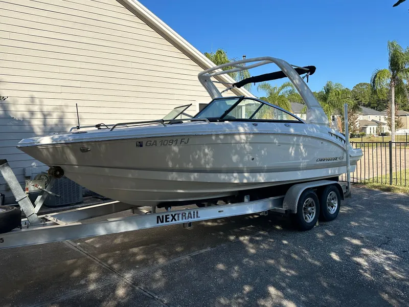 Slide: The Image of 2019 Chaparral 237 SSX boat on trailer, parked beside a house. - 21