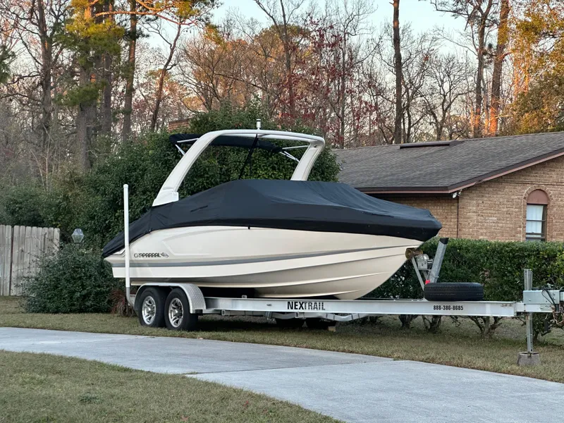 Slide: The Image of 2019 Chaparral 237 SSX boat on trailer, covered, parked in residential driveway. - 22