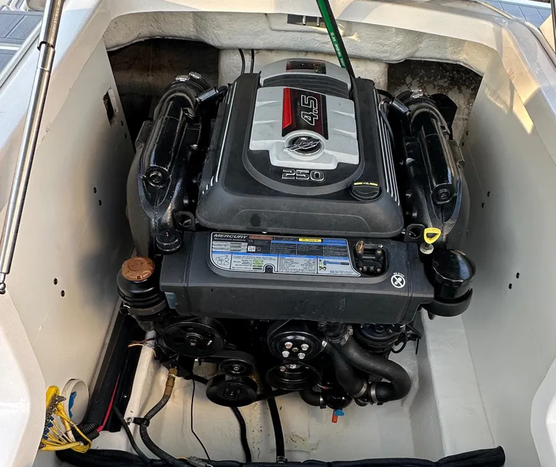 Slide: The Image of Engine compartment of a 2019 Chaparral 237 SSX boat, featuring a 4.5L 250 HP engine. - 23
