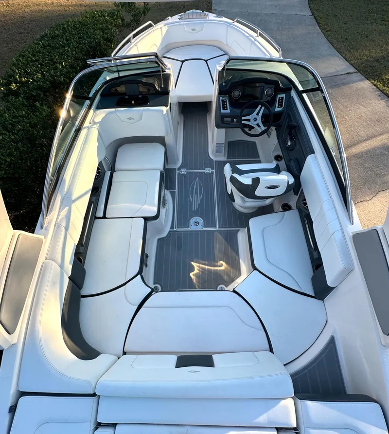Slide: The Image of 2019 Chaparral 237 SSX boat interior with white seating and modern dashboard. - 25