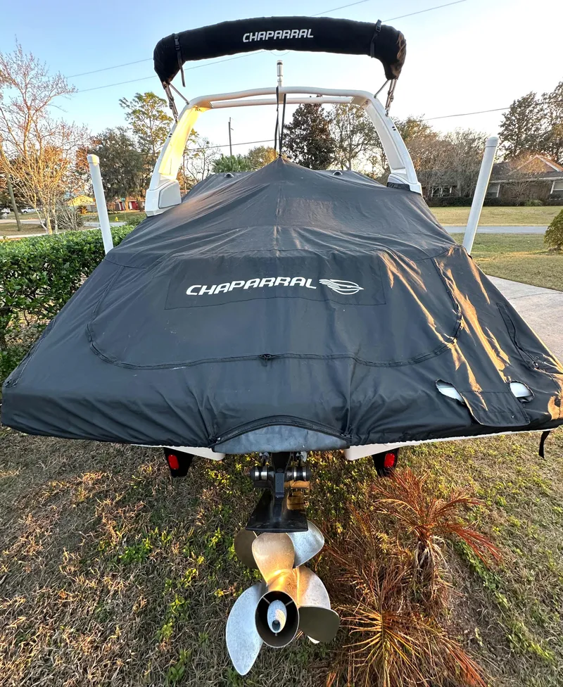 Slide: The Image of 2019 Chaparral 237 SSX boat with cover, rear view, parked outdoors. - 27