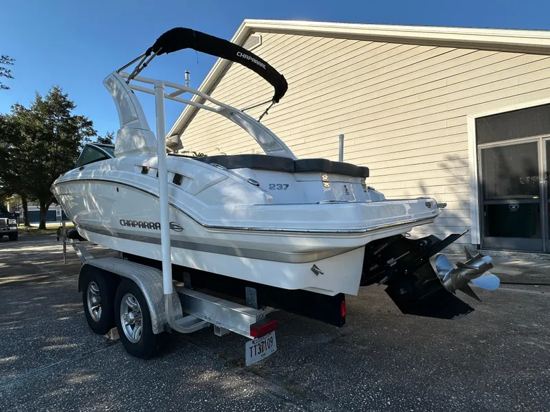 Slide: The Image of 2019 Chaparral 237 SSX boat on trailer, parked near a building. - 4