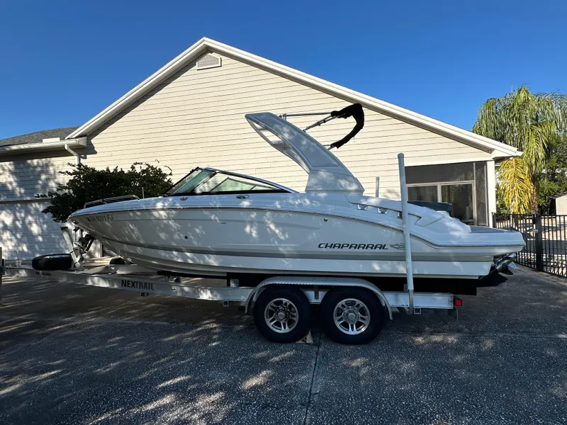 Slide: The Image of 2019 Chaparral 237 SSX boat on trailer, parked in driveway. - 5