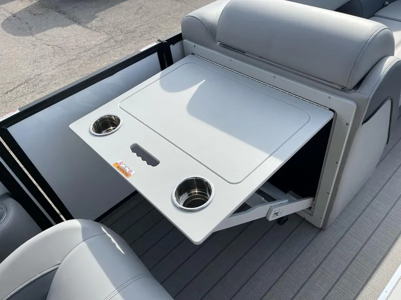 Slide: The Image of 2025 Bentley Pontoons Elite 223 Swingback interior with foldable table and cup holders. - 13