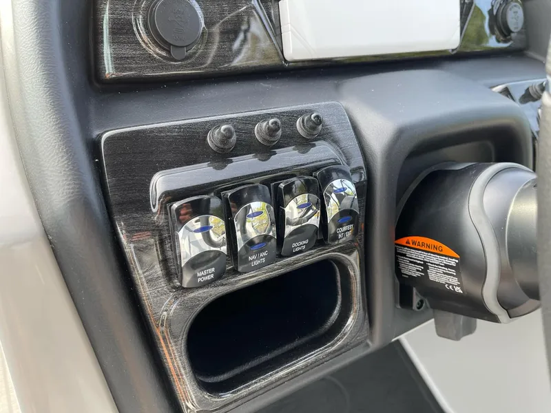 Slide: The Image of Control panel of 2025 Bentley Pontoons Elite 223 Swingback with labeled switches. - 17