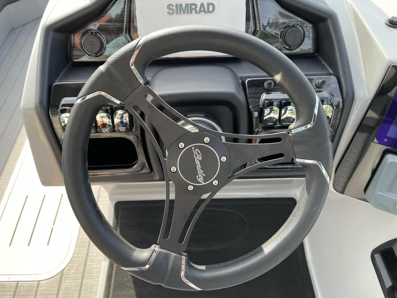 Slide: The Image of 2025 Bentley Pontoons Elite 223 Swingback steering wheel and dashboard controls. - 18
