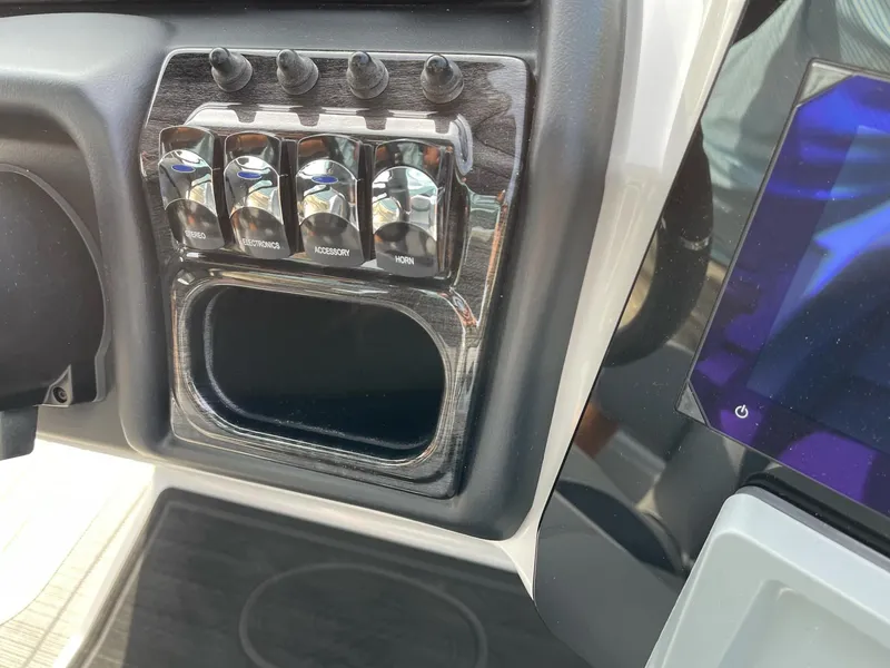 Slide: The Image of Control panel of 2025 Bentley Pontoons Elite 223 Swingback with switches and display. - 19