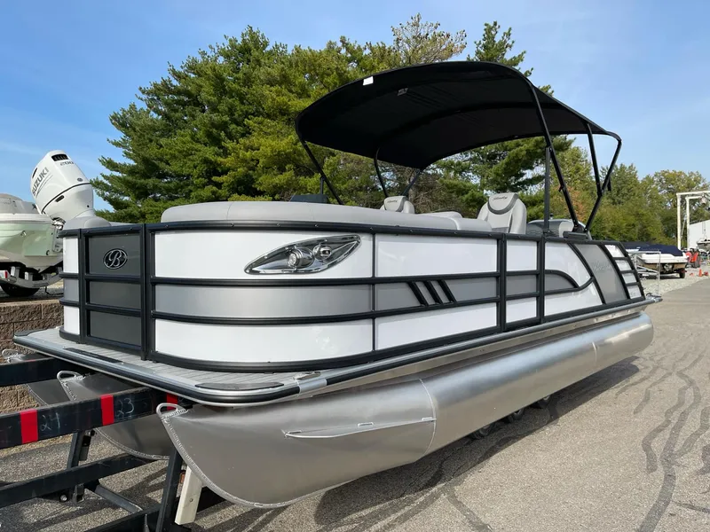 Slide: The Image of 2025 Bentley Pontoons Elite 223 Swingback pontoon boat with sleek design and canopy. - 2