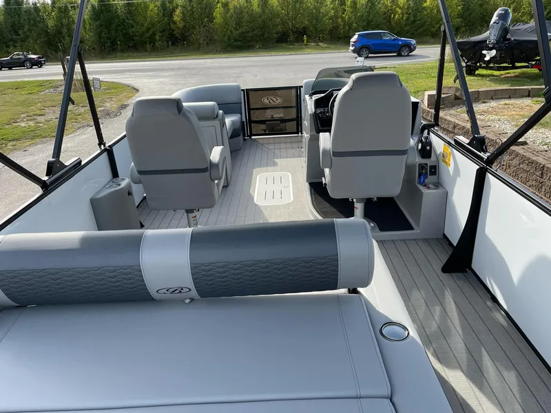 Slide: The Image of 2025 Bentley Pontoons Elite 223 Swingback interior with gray seating and modern design. - 25