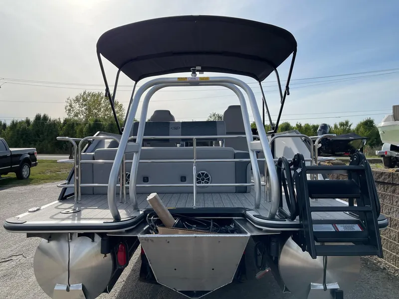 Slide: The Image of 2025 Bentley Pontoons Elite 223 Swingback, rear view with canopy and seating. - 5