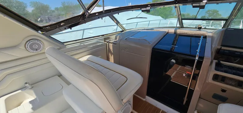 Slide: The Image of 1999 Sea Ray 400 Express Cruiser cockpit with beige seating and modern dashboard. - 11
