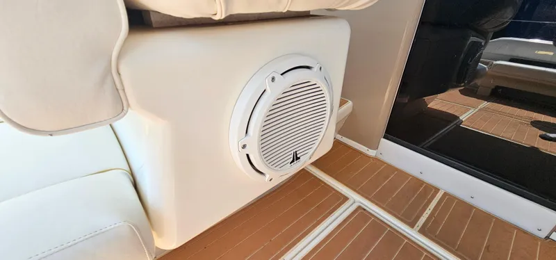 Slide: The Image of 1999 Sea Ray 400 Express Cruiser interior with speaker and cushioned seating. - 12