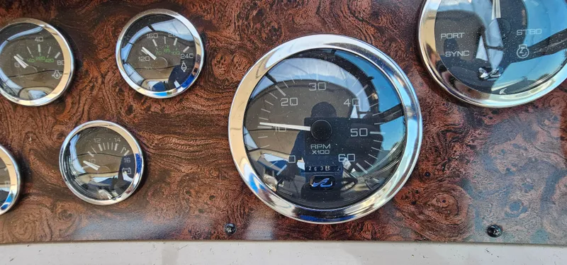 Slide: The Image of Dashboard gauges of a 1999 Sea Ray 400 Express Cruiser boat. - 15
