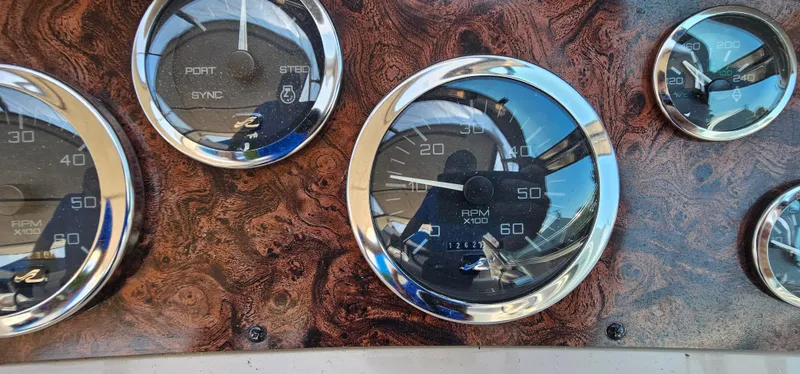 Slide: The Image of Dashboard gauges of a 1999 Sea Ray 400 Express Cruiser boat. - 16