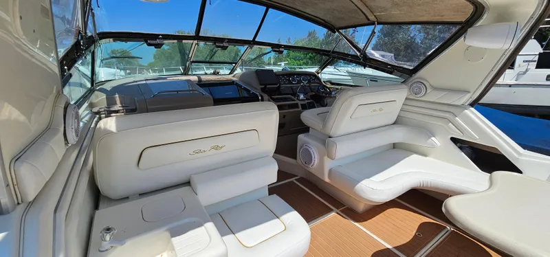 Slide: The Image of 1999 Sea Ray 400 Express Cruiser interior with white seating and modern dashboard. - 27