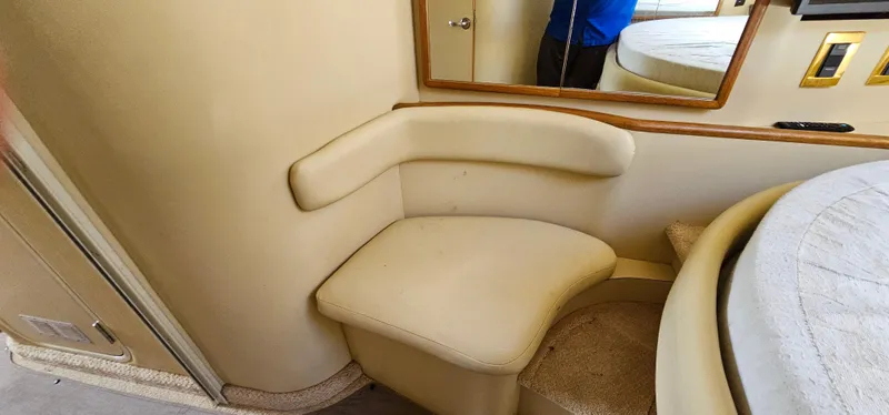 Slide: The Image of 1999 Sea Ray 400 Express Cruiser interior with beige seating and mirror. - 38