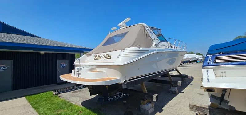 Slide: The Image of 1999 Sea Ray 400 Express Cruiser on dry dock under clear blue sky. - 4