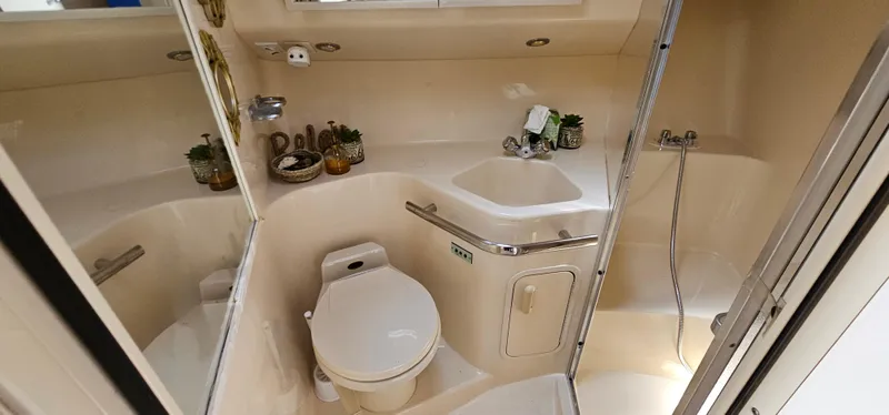 Slide: The Image of 1999 Sea Ray 400 Express Cruiser bathroom with toilet, sink, and shower. - 40