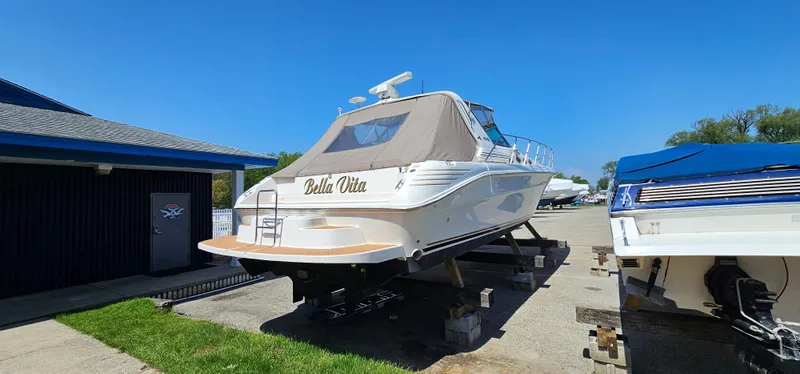 Slide: The Image of 1999 Sea Ray 400 Express Cruiser on dry dock, sunny day, blue sky. - 42