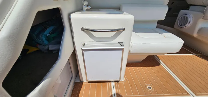 Slide: The Image of 1999 Sea Ray 400 Express Cruiser interior with white seating and wooden flooring. - 9