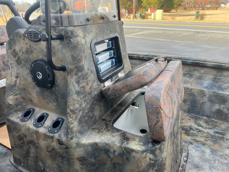 Slide: The Image of Excel 2072 Stalker SC 2025 boat interior with camouflage design and storage compartments. - 12