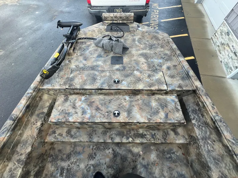 Slide: The Image of Camouflage-patterned Excel 2072 Stalker SC boat interior, 2025 model, with storage compartments. - 4