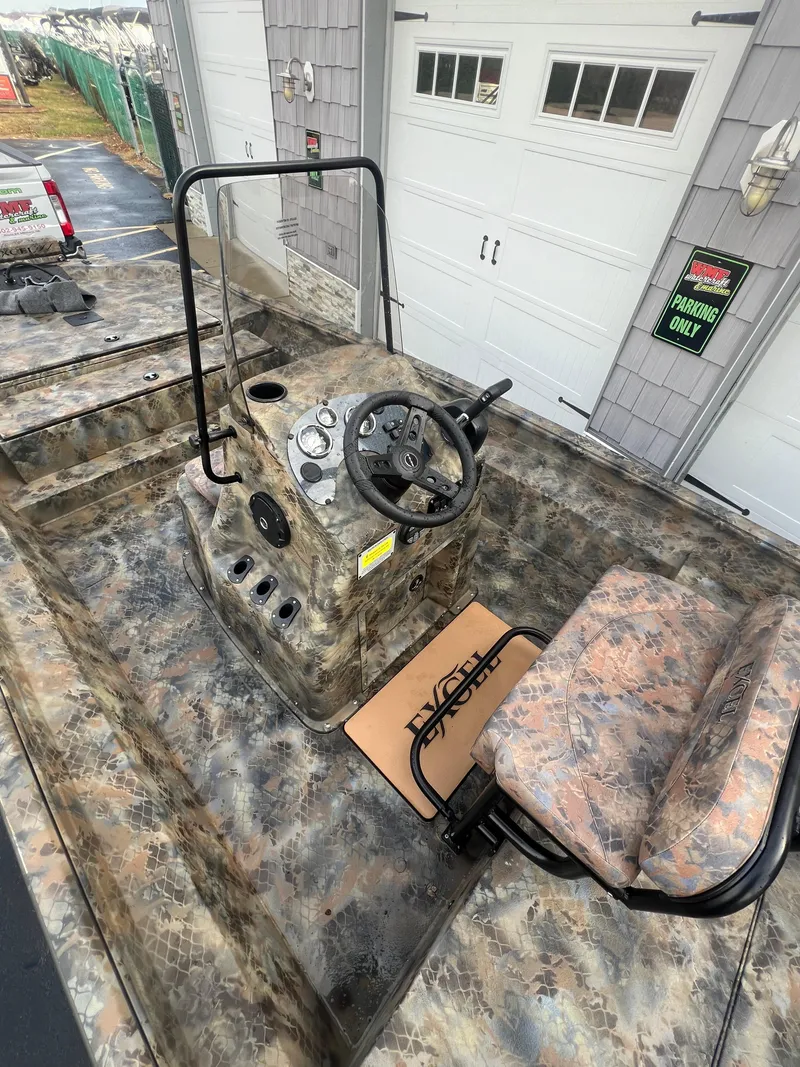 Slide: The Image of Camouflage-patterned 2025 Excel 2072 Stalker SC boat interior with steering console and seat. - 6