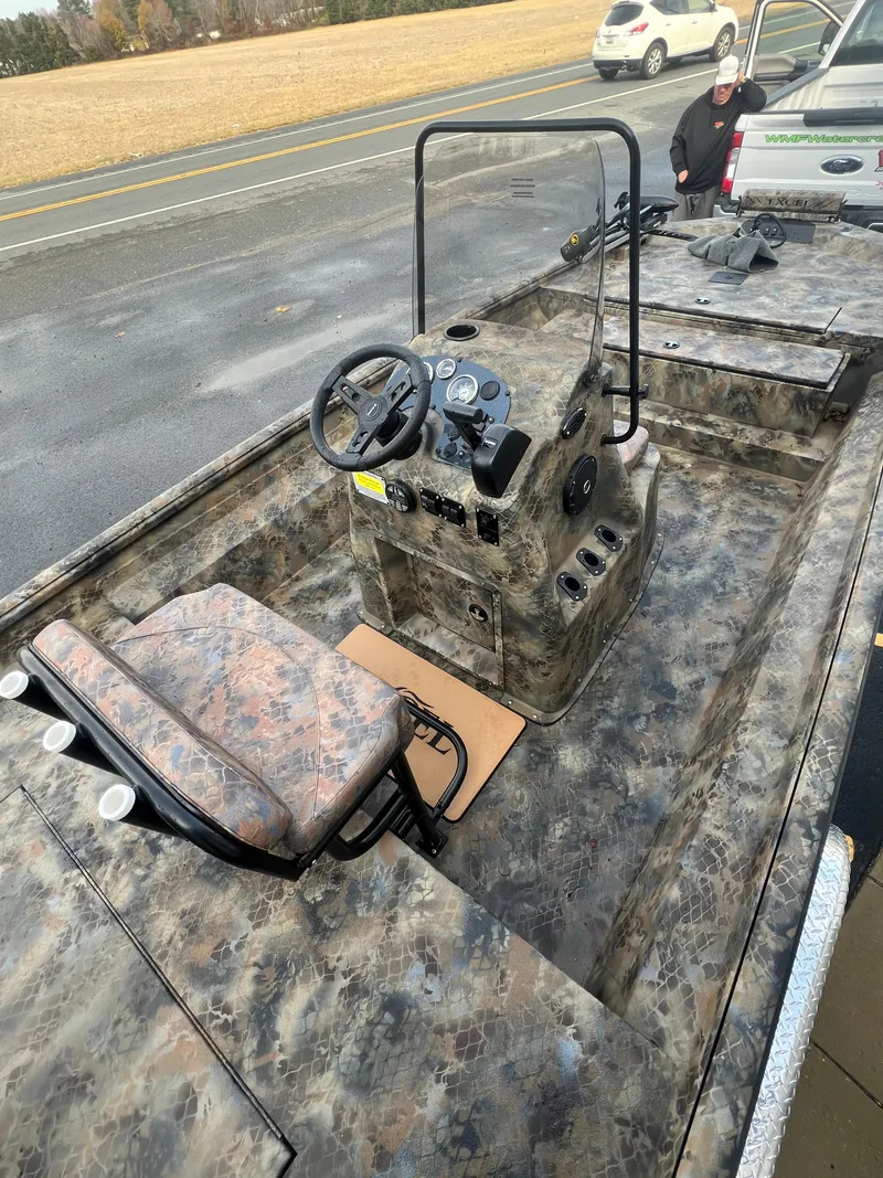 Slide: The Image of 2025 Excel 2072 Stalker SC boat with camouflage design and steering console. - 7